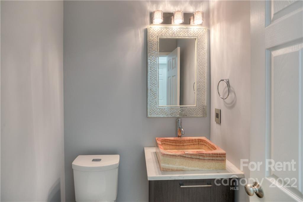 2857 Windsor Chase Drive Matthews, NC 28105 - Photo 21 of 46 a bathroom with a toilet sink and mirror