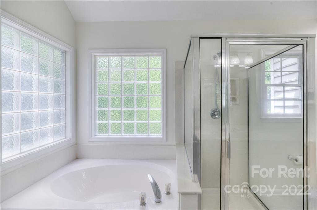 2857 Windsor Chase Drive Matthews, NC 28105 - Photo 35 of 46 a bathroom with a bathtub and a shower