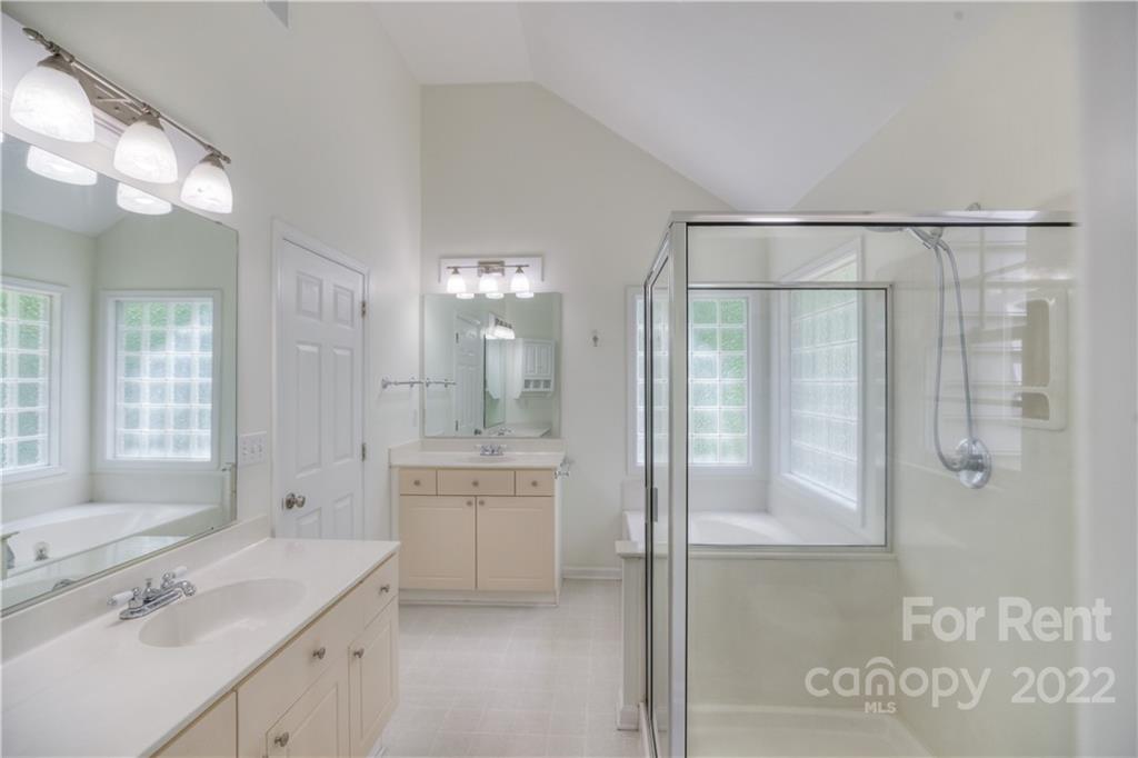 2857 Windsor Chase Drive Matthews, NC 28105 - Photo 36 of 46 a bathroom with a granite countertop sink a mirror a shower and a bathtub
