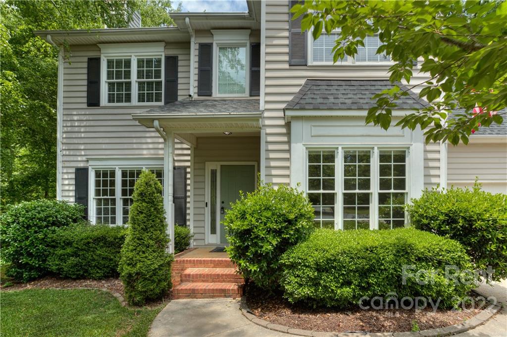 2857 Windsor Chase Drive Matthews, NC 28105 - Photo 5 of 46 front view of a house with a yard and potted plants