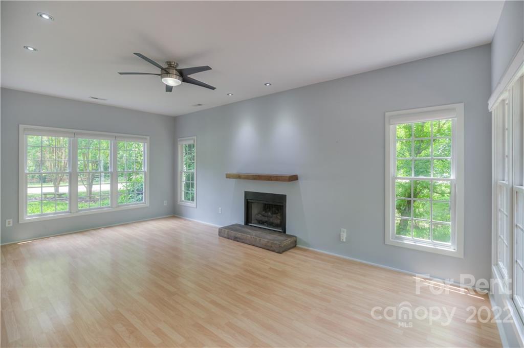 2857 Windsor Chase Drive Matthews, NC 28105 - Photo 9 of 46 an empty room with windows and fireplace