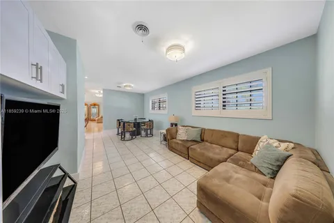 a living room with furniture a dining table and kitchen view