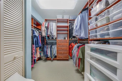 a large kitchen with cabinets wooden floor and stainless steel appliances