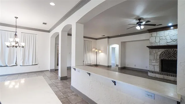 a large hall with chandelier fan and windows