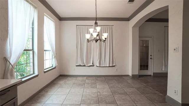 a view of an entryway with chandelier and glass door