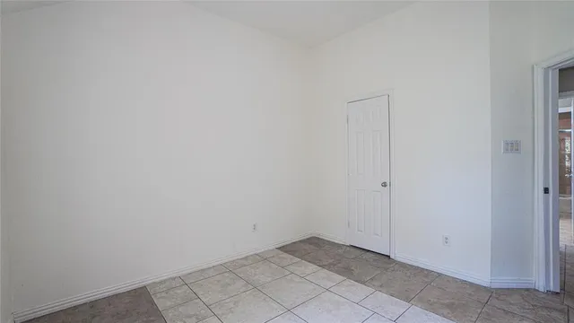 a view of a room with an empty space and a window