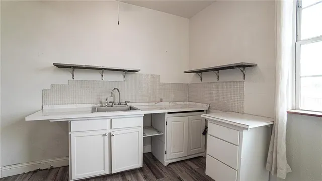 a view of empty room with large windows