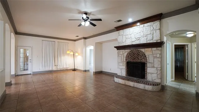a view of an empty room with a fireplace