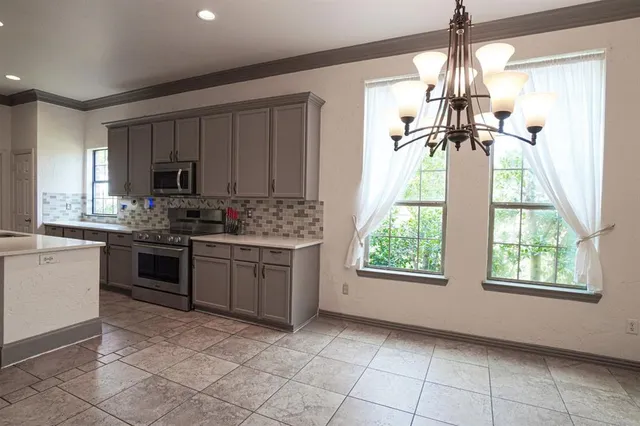 a kitchen with a stove a sink and a microwave