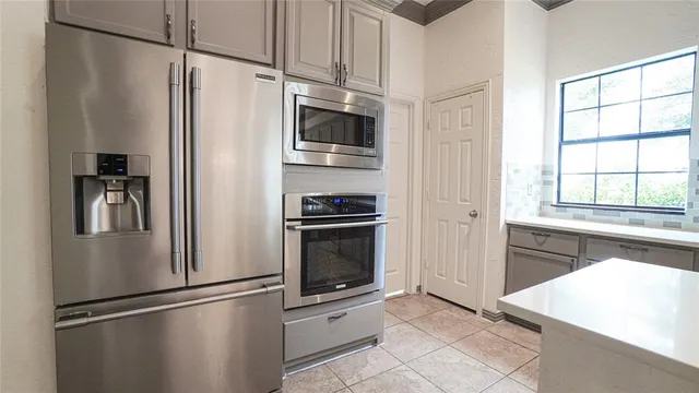 a kitchen with stainless steel appliances a refrigerator stove and microwave