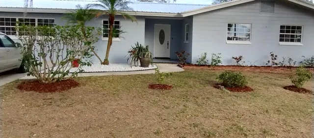 a front view of a house with garden