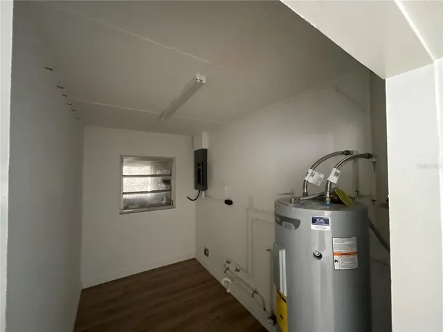 a kitchen with stainless steel appliances granite countertop a refrigerator a sink dishwasher a stove and white countertops with wooden floor