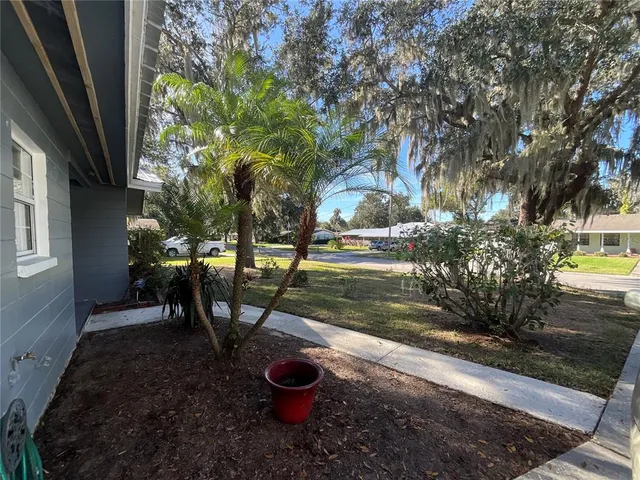 a view of a backyard with table and chairs and potted plants