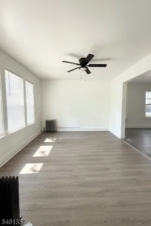 a view of a room with wooden floor and window