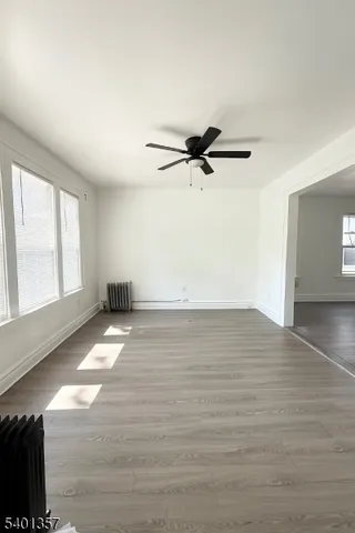 a view of a room with wooden floor and window