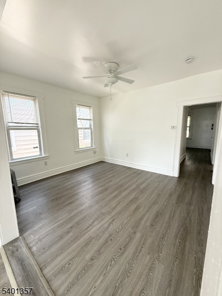 237 Wainwright Street Newark, NJ 07112 - Photo 4 of 5 an empty room with wooden floor and windows