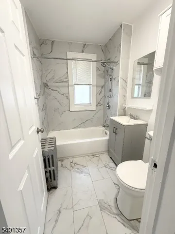 a bathroom with a toilet a sink a bath tub and a shower