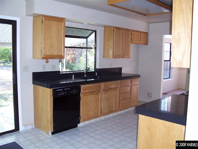 1739 Rainbow Ridge Road Reno, NV 89523 - Photo 5 of 8 a kitchen with granite countertop a sink cabinets and window