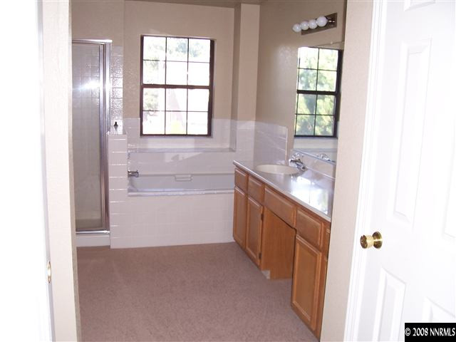 1739 Rainbow Ridge Road Reno, NV 89523 - Photo 8 of 8 a bathroom with a sink vanity granite tub and a window