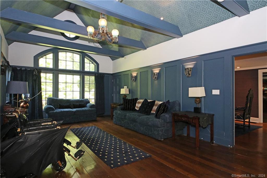 22 Ketcham Road Ridgefield, CT 06877 - Photo 29 of 40 a living room with furniture and a chandelier