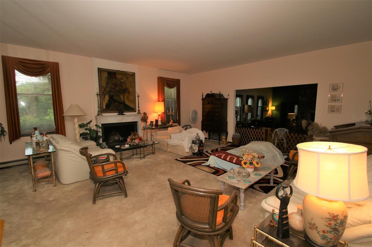 7610 Garden Prairie Road Garden Prairie, IL 61038 - Photo 13 of 25 a living room with furniture a fireplace and a flat screen tv