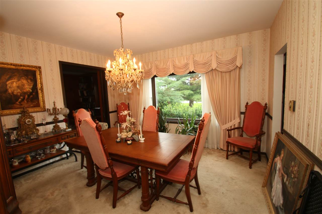 7610 Garden Prairie Road Garden Prairie, IL 61038 - Photo 14 of 25 a view of a dining room with furniture and a chandelier