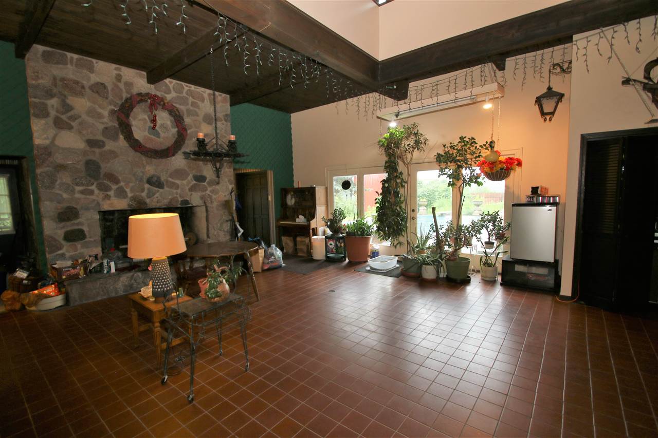 7610 Garden Prairie Road Garden Prairie, IL 61038 - Photo 17 of 25 a view of a livingroom with furniture and a fireplace