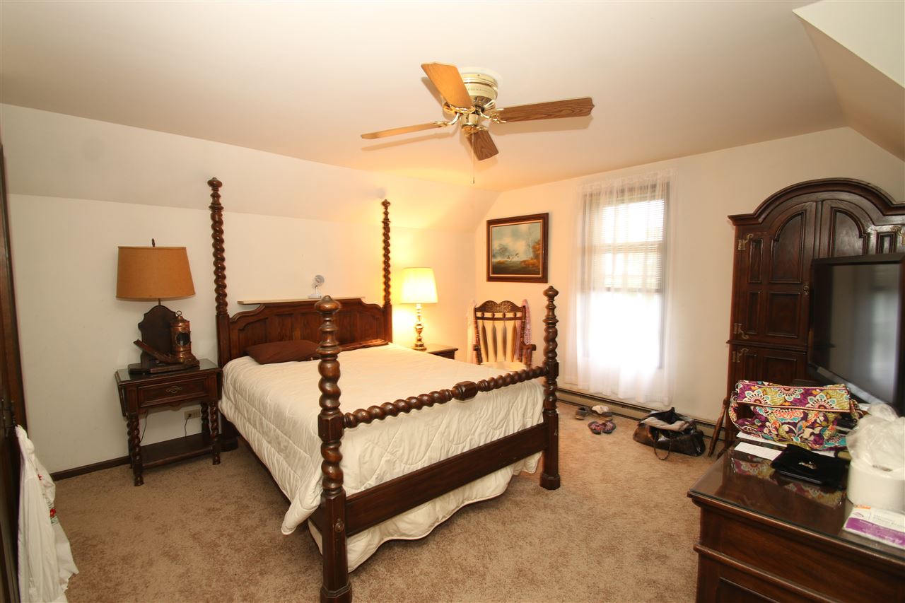 7610 Garden Prairie Road Garden Prairie, IL 61038 - Photo 18 of 25 a bed room with a bed window and a dresser