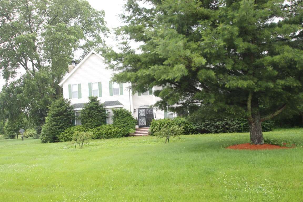 7610 Garden Prairie Road Garden Prairie, IL 61038 - Photo 2 of 25 a front view of a house with a yard and tree s