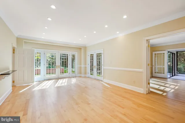 a view of a room with a fireplace chandelier and glass door