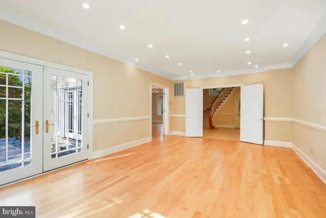a kitchen with stainless steel appliances granite countertop a refrigerator and a stove top oven with wooden floor