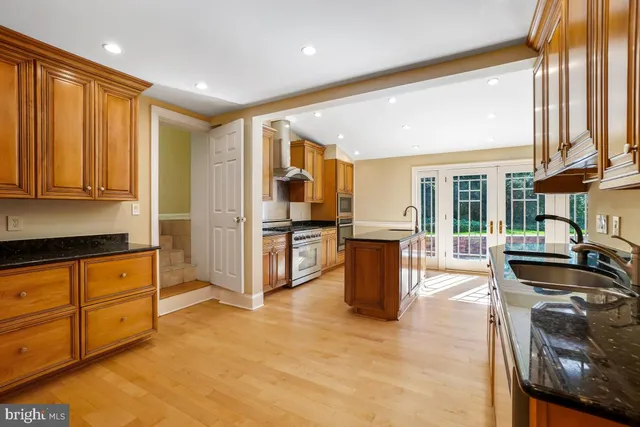a open kitchen with granite countertop sink and cabinets