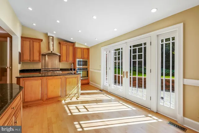 a kitchen with granite countertop a sink and cabinets