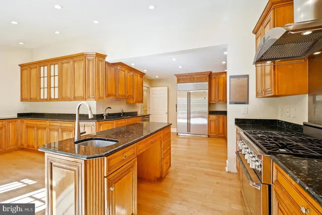 a kitchen with stainless steel appliances granite countertop a stove and a sink