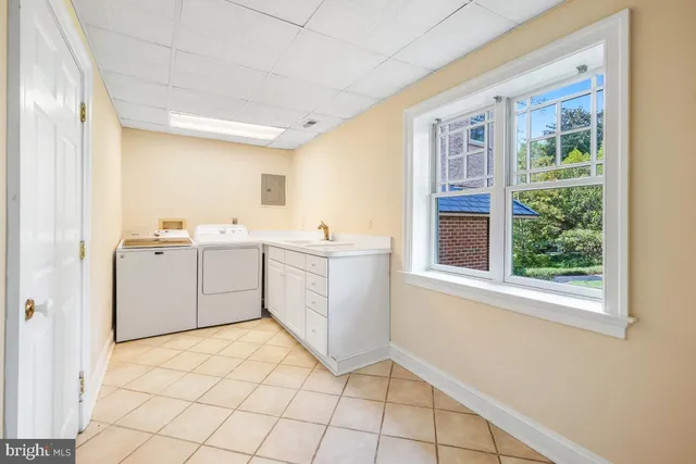 an empty room with windows fireplace and wooden floor
