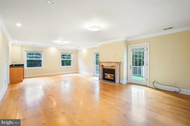 a large kitchen with kitchen island a large window in it