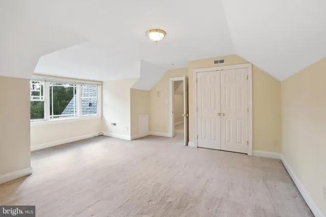 a view of a hallway with wooden shelves