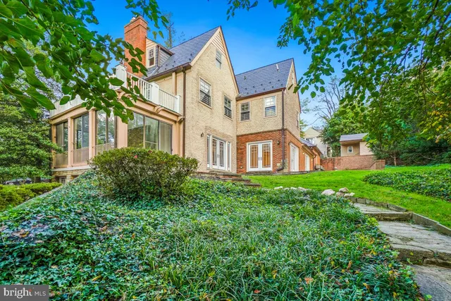 a view of a car parked in front of a house with a garage