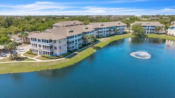 an aerial view of residential houses with outdoor space and ocean view