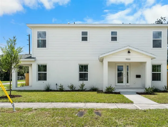 a view of a house with backyard and garden