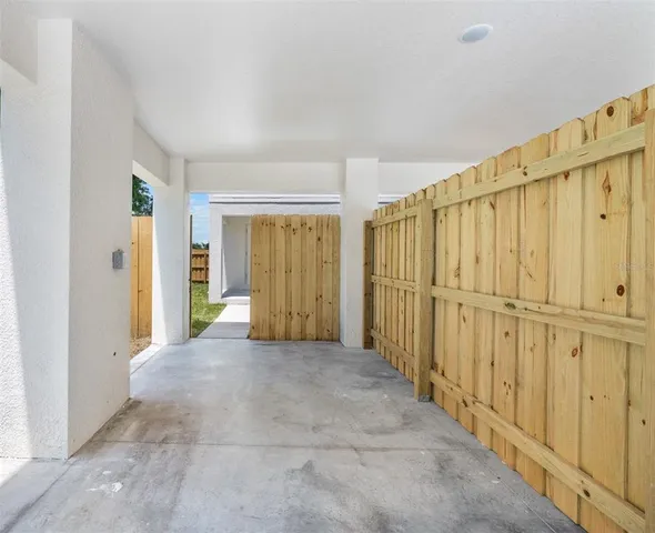 a view of a hallway with wooden walls