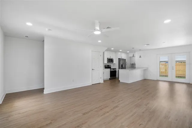 a view of a kitchen with wooden floor and a kitchen