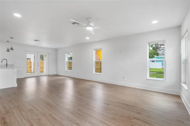 an empty room with window and wooden floor