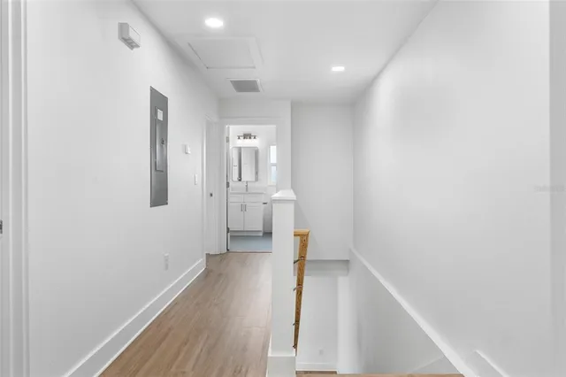 a view of a hallway with wooden floor
