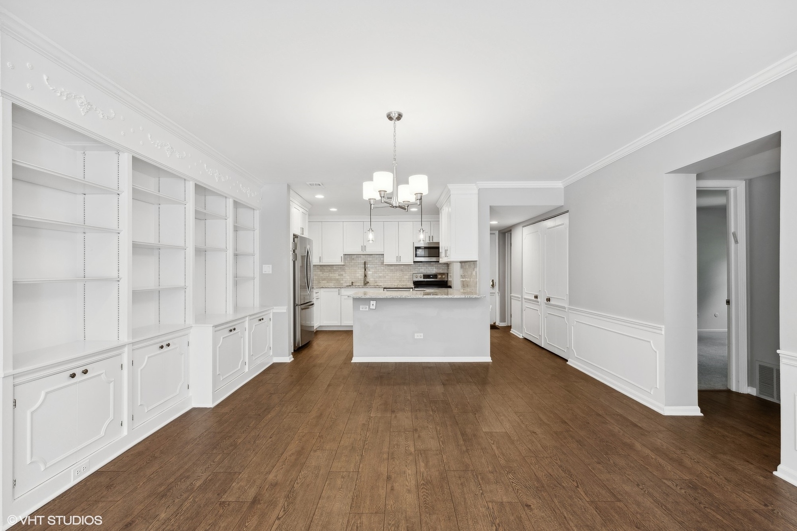 2425 Central Street, Unit 2B Evanston, IL 60201 - Photo 7 of 17 a large kitchen with kitchen island a white cabinets and wooden floor
