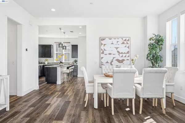 a dining room with furniture and wooden floor
