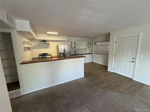 a kitchen with stainless steel appliances a refrigerator and a sink