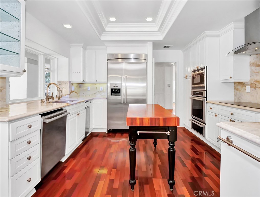 7 Hillcrest Meadows Rolling Hills Estates, CA 90274 - Photo 13 of 49 a kitchen with stainless steel appliances a stove sink and cabinets
