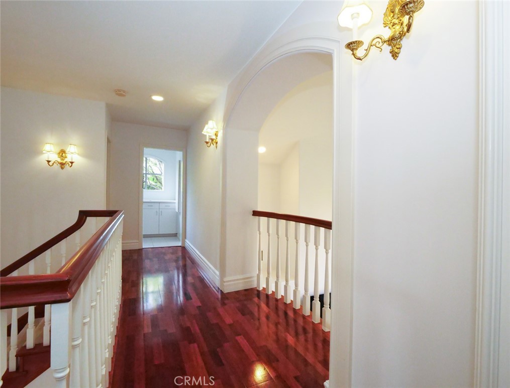 7 Hillcrest Meadows Rolling Hills Estates, CA 90274 - Photo 29 of 49 a view of a hallway with wooden floor and staircase