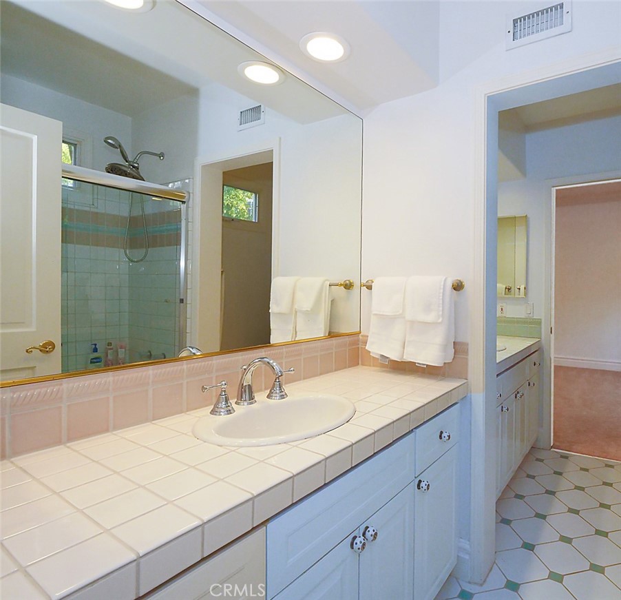 7 Hillcrest Meadows Rolling Hills Estates, CA 90274 - Photo 36 of 49 a bathroom with a sink and a mirror